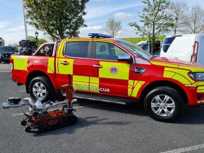 ICP NewTech Avenger Fire UGV beside an emergency response vehicle