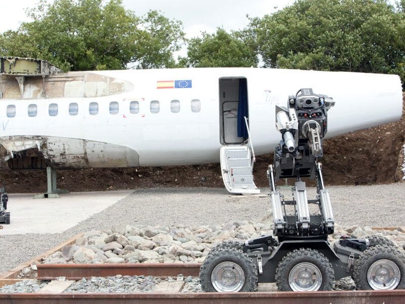 ICP NewTech UGV training exercise beside an aircraft